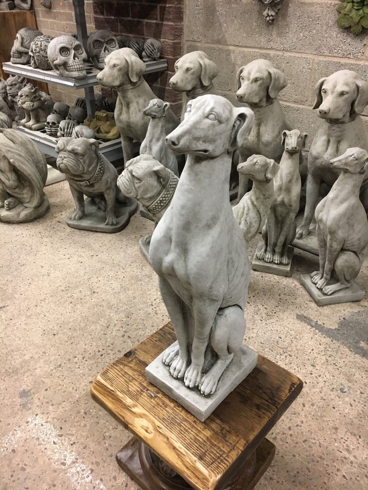 Greyhound statue with upright posture and smooth limestone finish, ideal for outdoor garden or porch ornamentation.