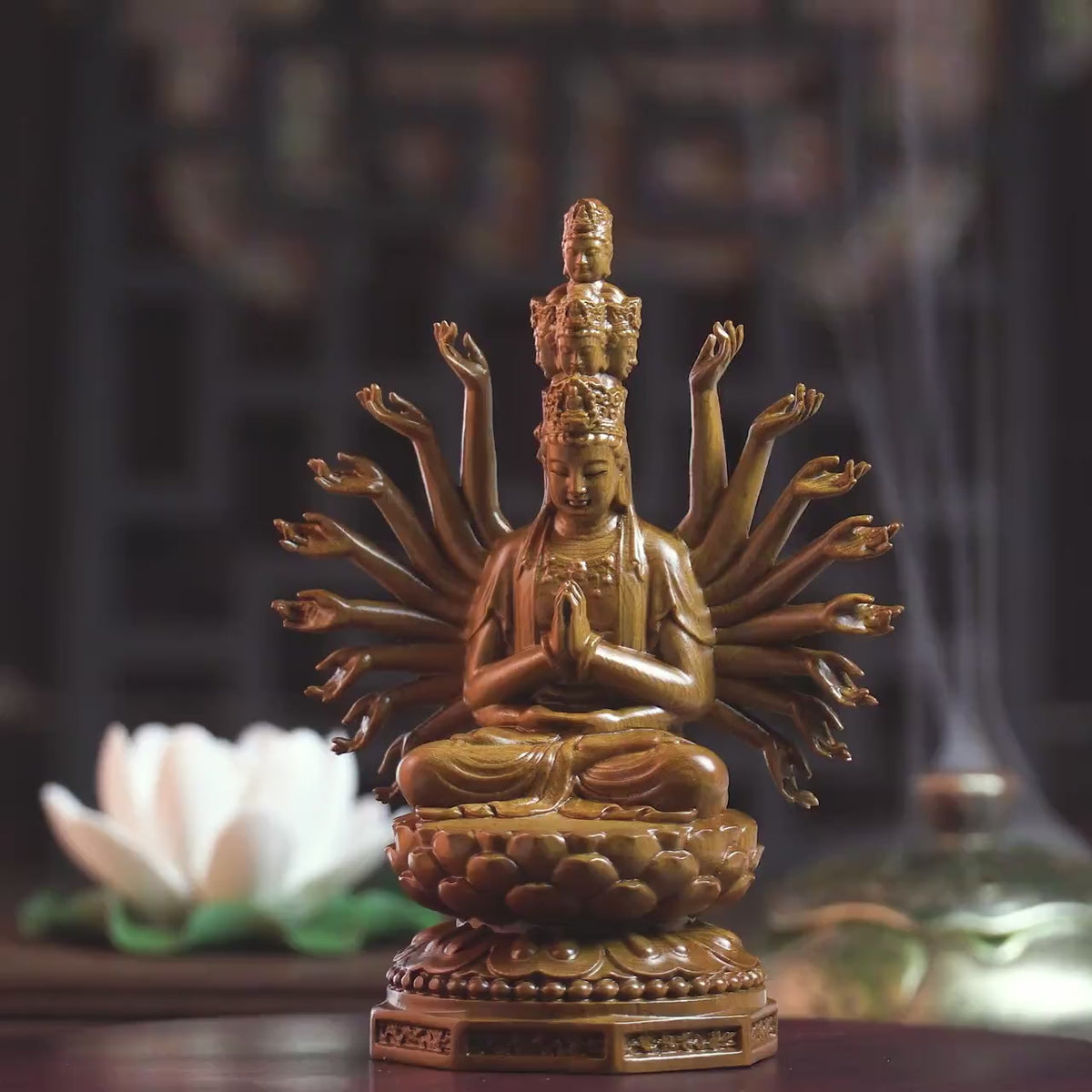 Front view of Wooden Guan Yin Meditation Statue with incense smoke and lotus flower. A calming addition to sacred spaces.