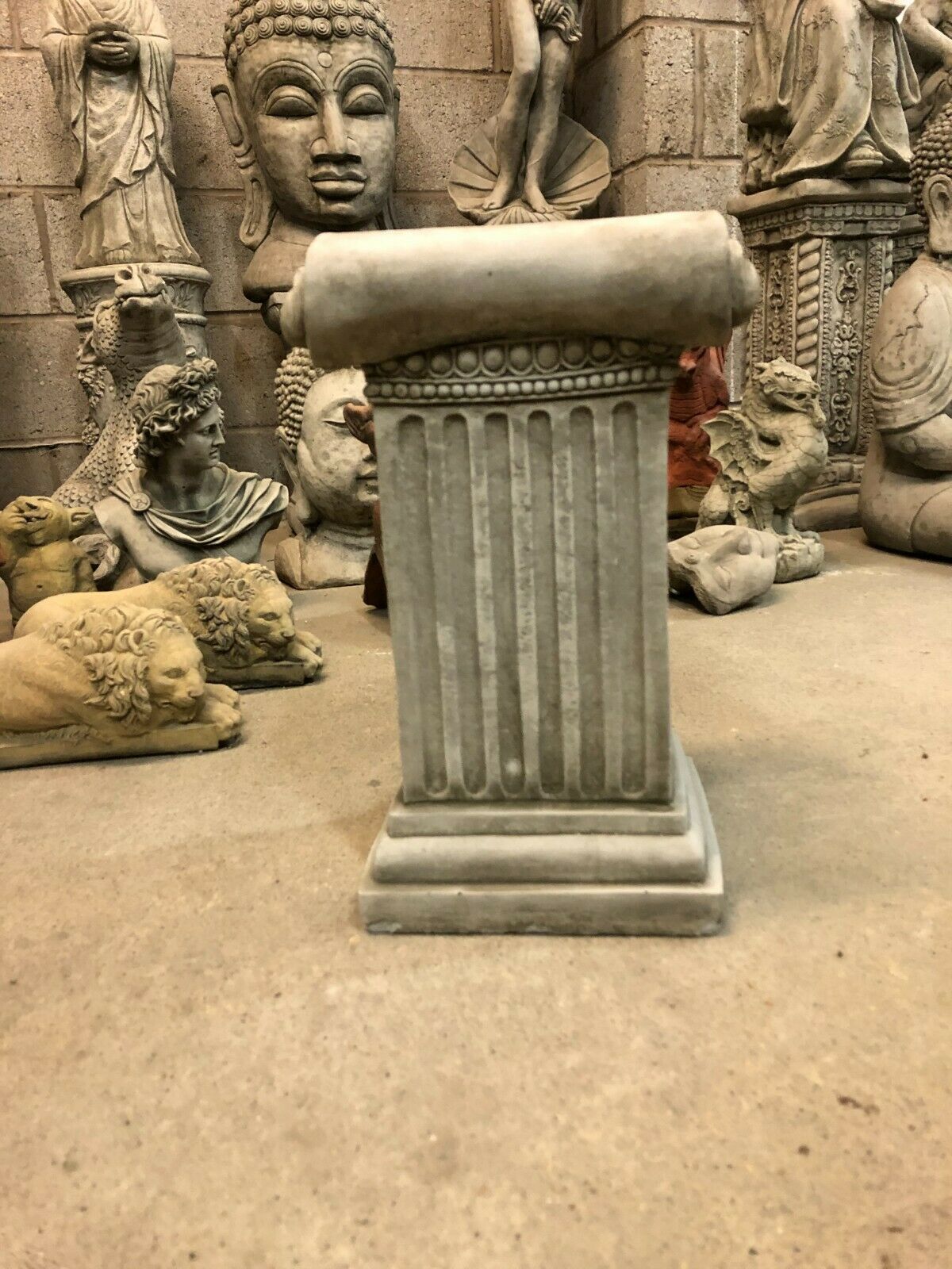 Stone Roman Style Garden Plinth with antique finish, showcasing a classic Ionic column shape, perfect for garden or patio decor.