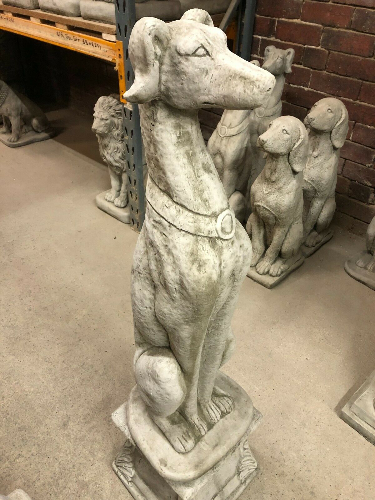 Single Elegant Stone Greyhound Dog Garden Statue on a decorative pedestal, showcasing lifelike detail and durable stone construction for UK gardens.