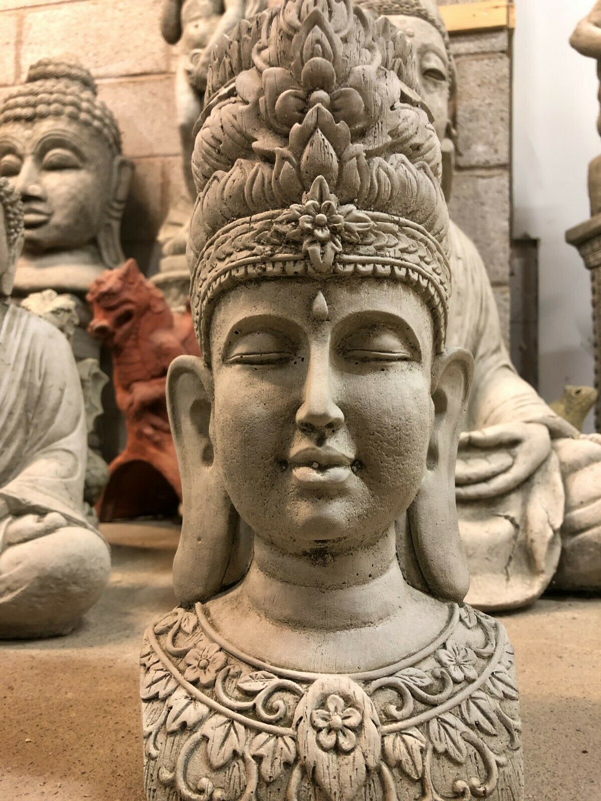 Front close-up of Tranquil Stone Buddha Bust - Garden Ornament with peaceful facial features and floral detailing for spiritual garden ambiance.