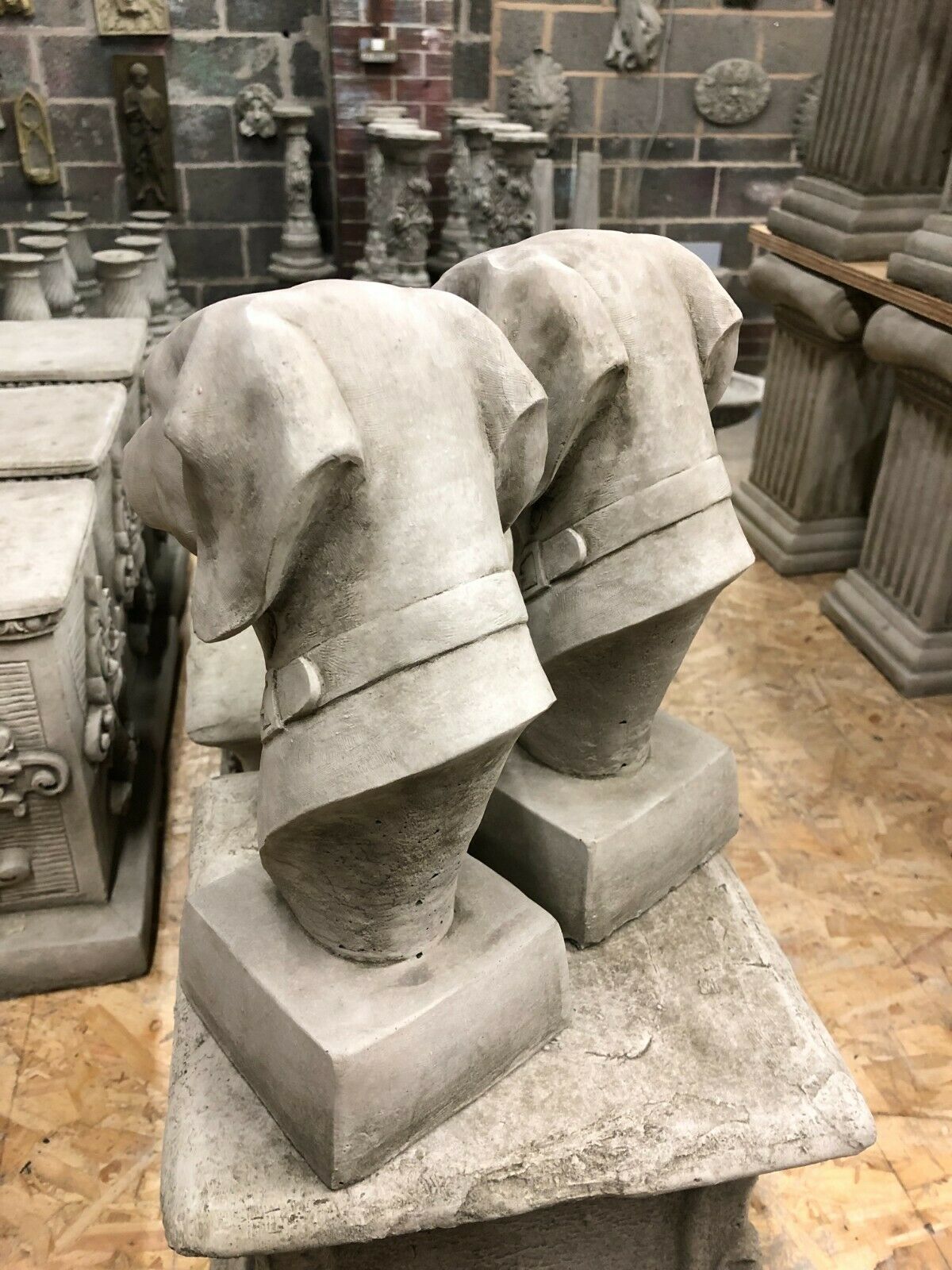 Rear view of Stone Greyhound Finials showing detailed collars and antique limestone texture, designed for garden or patio pillars.