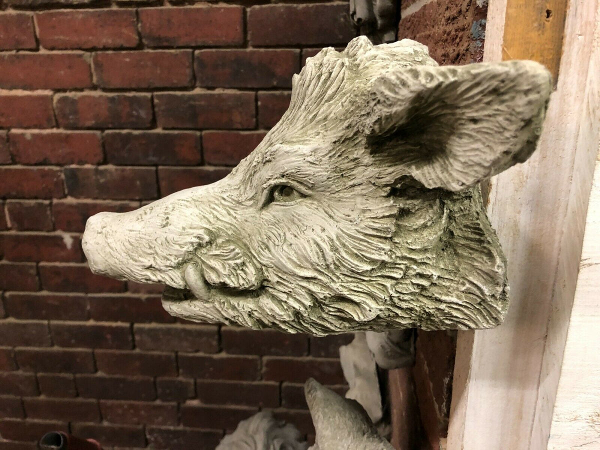 Close-up side profile of Wild Boar Wall Plaque in limestone, highlighting intricate carving. A standout piece for home or garden walls.