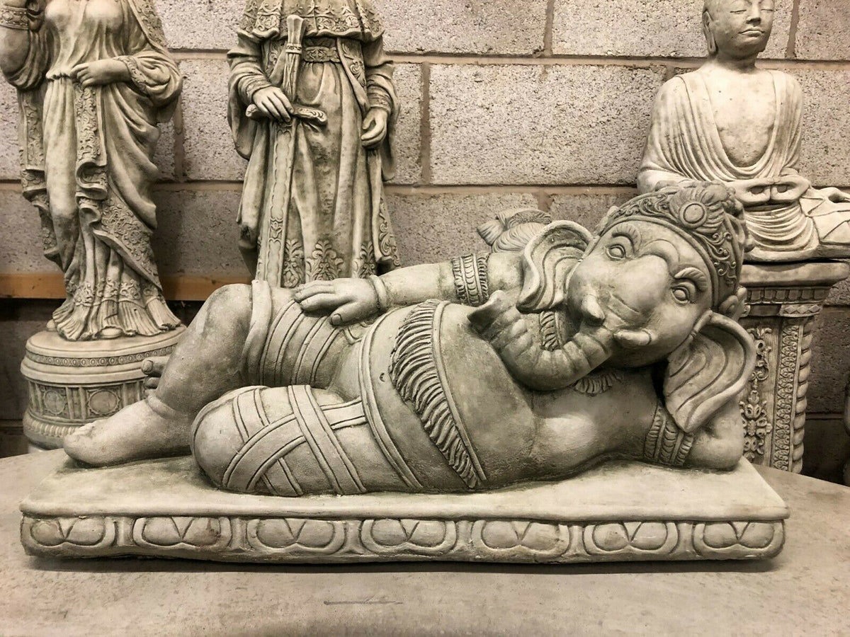 Ganesh Garden Statue in laying down pose, crafted from durable stone with intricate detailing. Ideal for outdoor garden or patio decor.