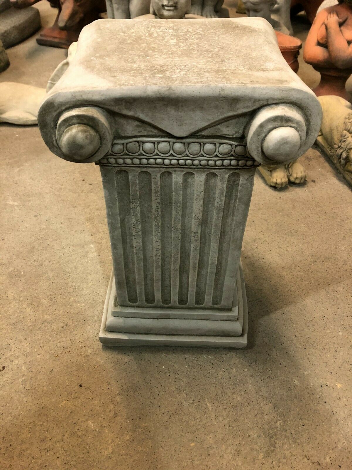 Antique finish Stone Roman Style Garden Plinth featuring a square base and detailed Ionic capital, suitable for decorative garden use.