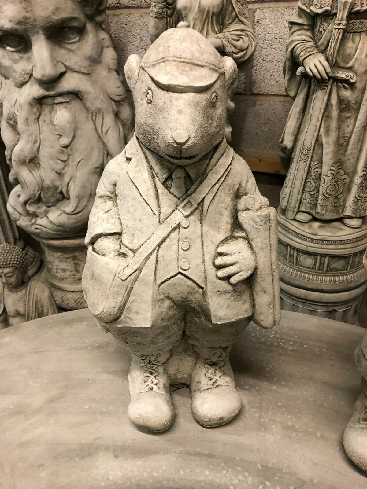 Poacher statue from Stone Gamekeeper & Poacher Statues-Garden Decor | Solid & Durable. Features cap, boots, and bag, crafted in weather-resistant stone.