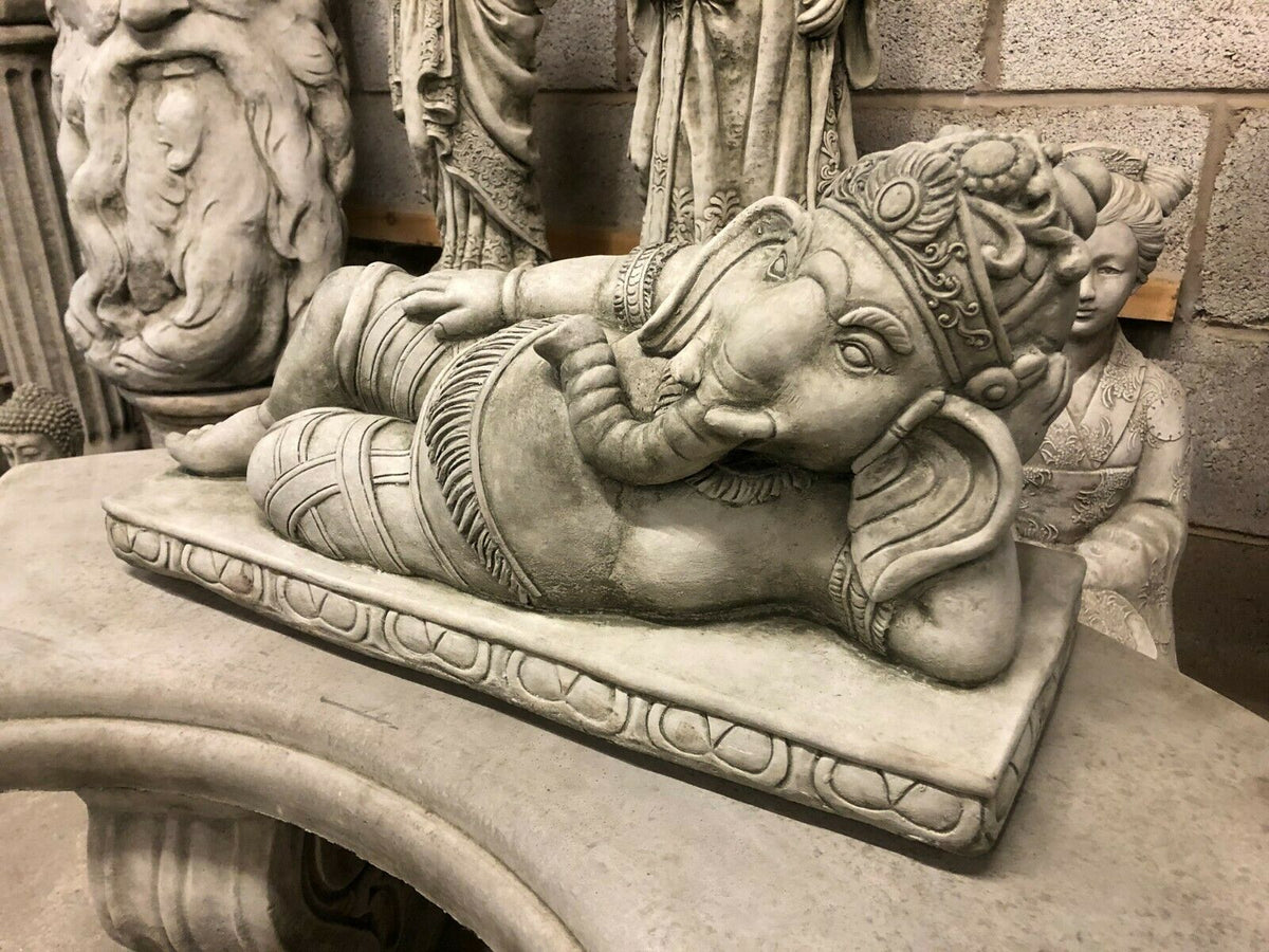 Detailed side view of Ganesh Garden Statue in reclining position, made from solid concrete for long-lasting outdoor decoration.