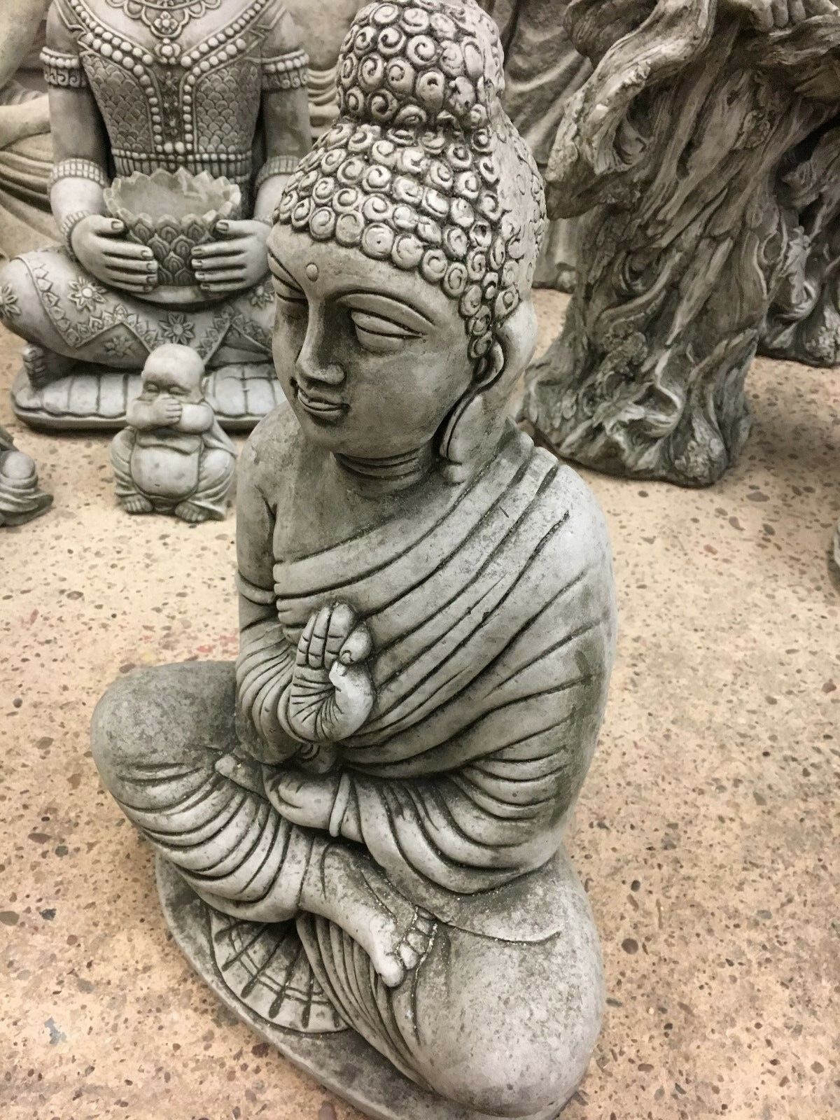 Angled side view of Stone Jnana Mudra Buddha Statue, emphasizing its calm facial features and symbolic hand gesture for outdoor decor.