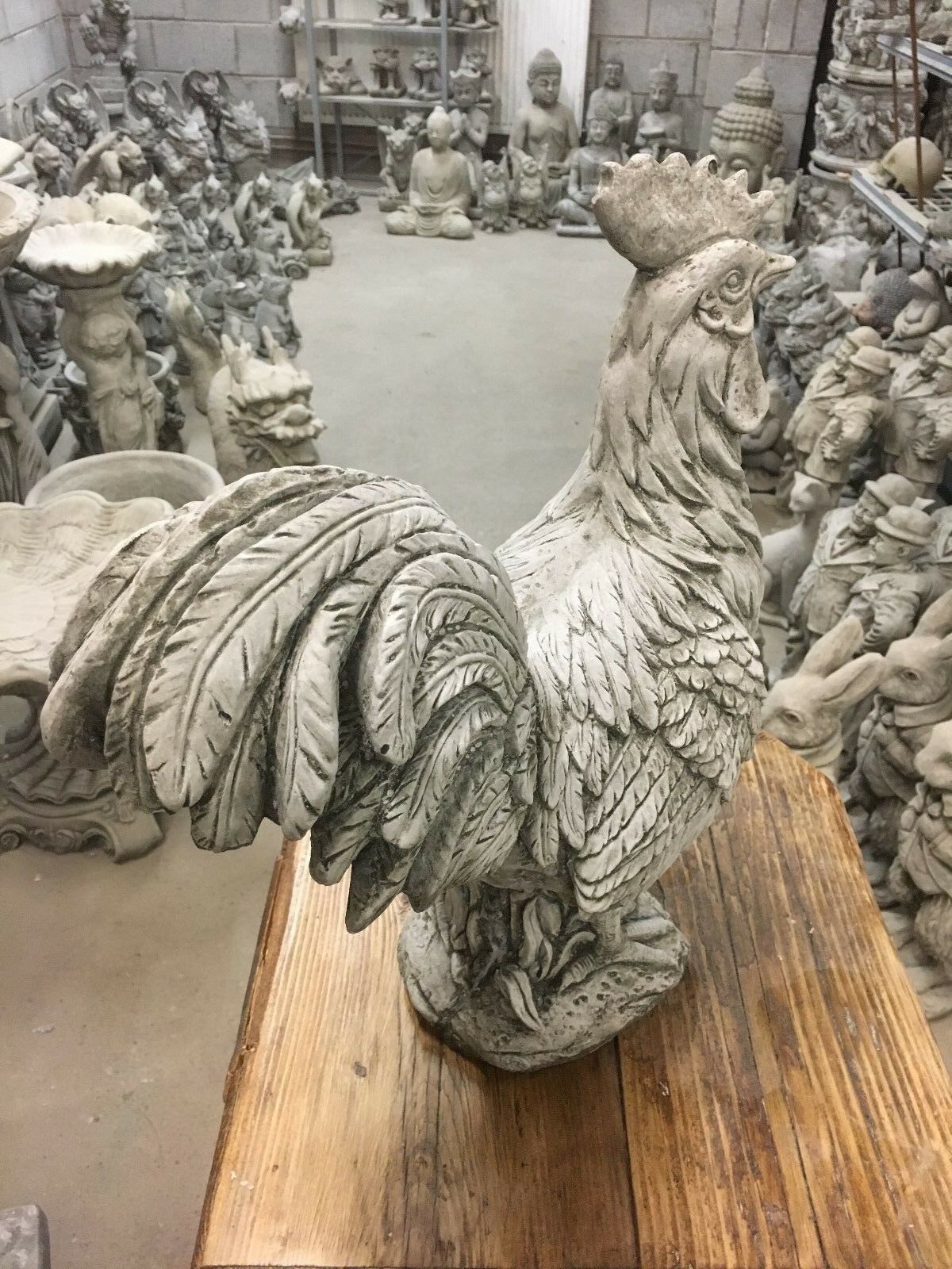 Detailed limestone rooster statue with raised tail feathers, designed for decorative use in gardens, patios, or outdoor living spaces.
