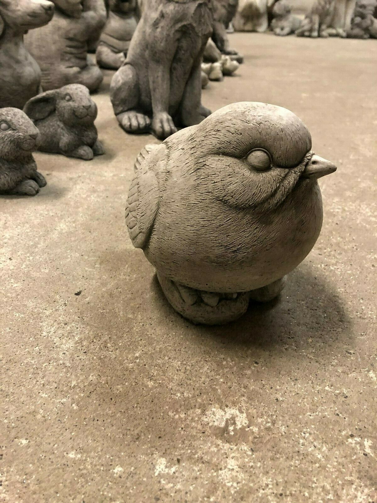 Weatherproof Stone Bird Garden Sculpture with rounded body and carved feather details. Great for garden landscapes or porch decor.