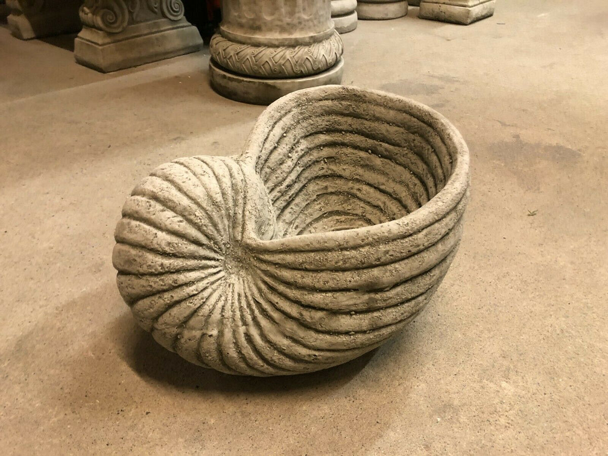 Side angle of Antique Grey Stone Shell Design Garden Planter Pot with weathered limestone finish, ideal for patios and garden spaces.