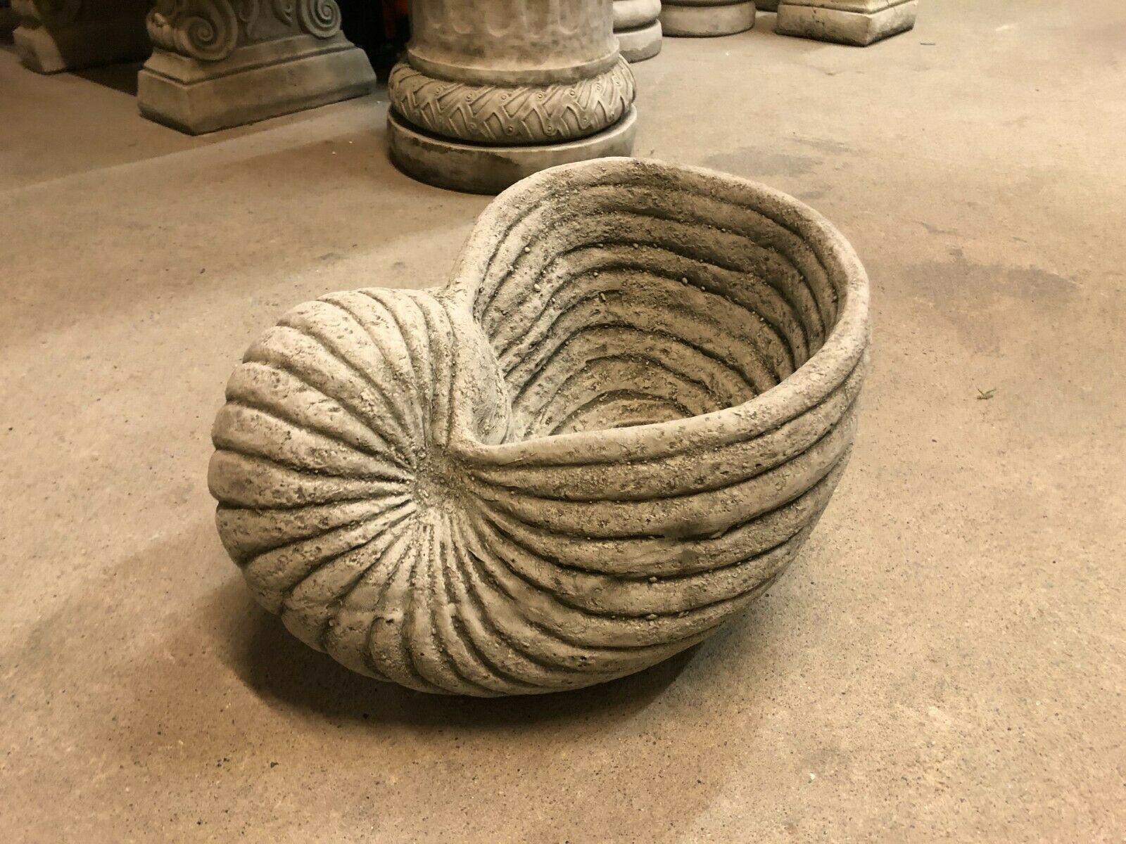 Side angle of Antique Grey Stone Shell Design Garden Planter Pot with weathered limestone finish, ideal for patios and garden spaces.