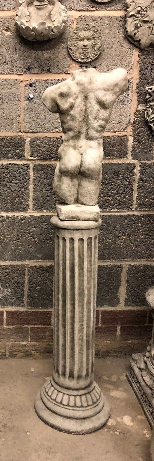 Rear view of male torso sculpture on Grecian column, showcasing muscular back. Durable stone garden ornament with antique finish.