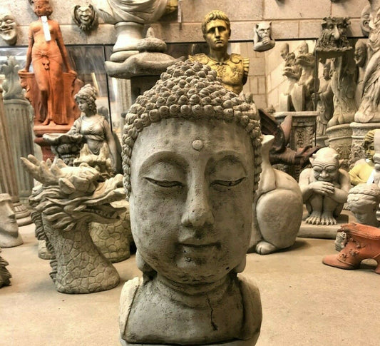 Large stone Buddha head statue with antique finish, ideal for garden decor. Solid limestone sculpture for outdoor or patio display.