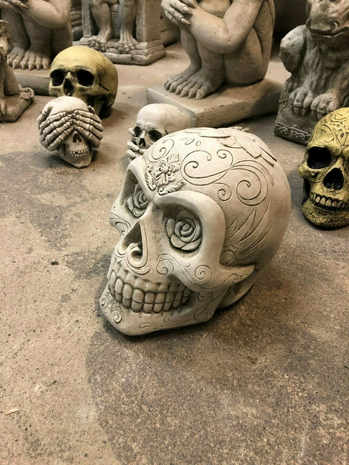 Crack-resistant Stone Skull Garden Ornament with intricate rose and swirl patterns. Ideal for patios or gothic garden setups.