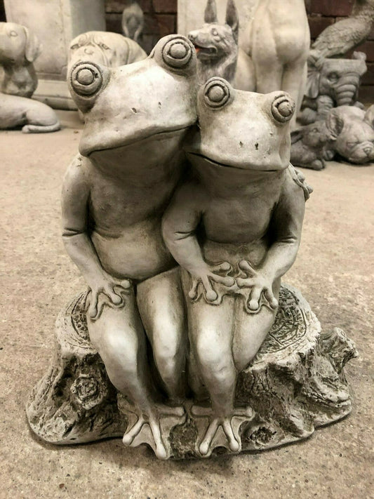 Elegant Frog Couple Ornament in fine limestone, seated on a tree stump with arms entwined. Ideal stone garden decor for romantic outdoor charm.