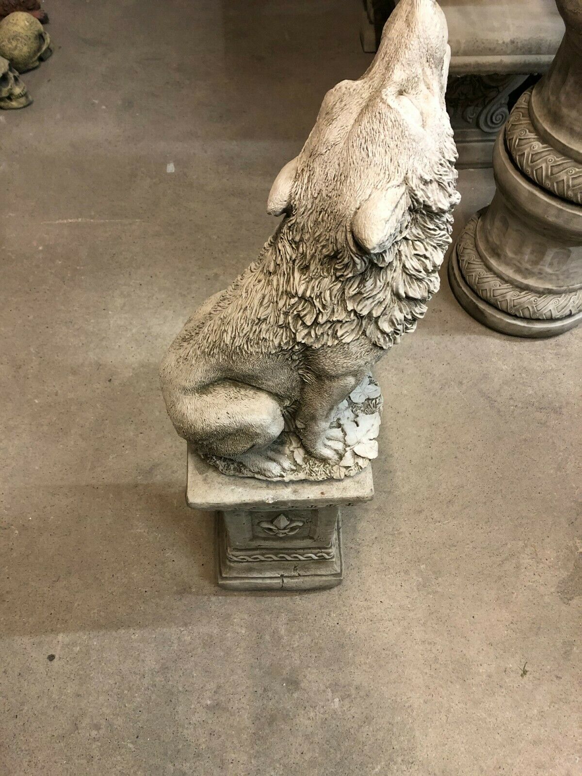 Top view of Howling Wolf Statue showing intricate fur texture and antique stone finish, mounted on a decorative garden pedestal.