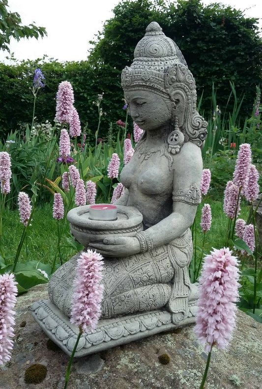 Geisha Statue Candle Holder - Stone Praying Geisha kneeling on a rock among pink flowers, holding a tealight bowl for garden decor.