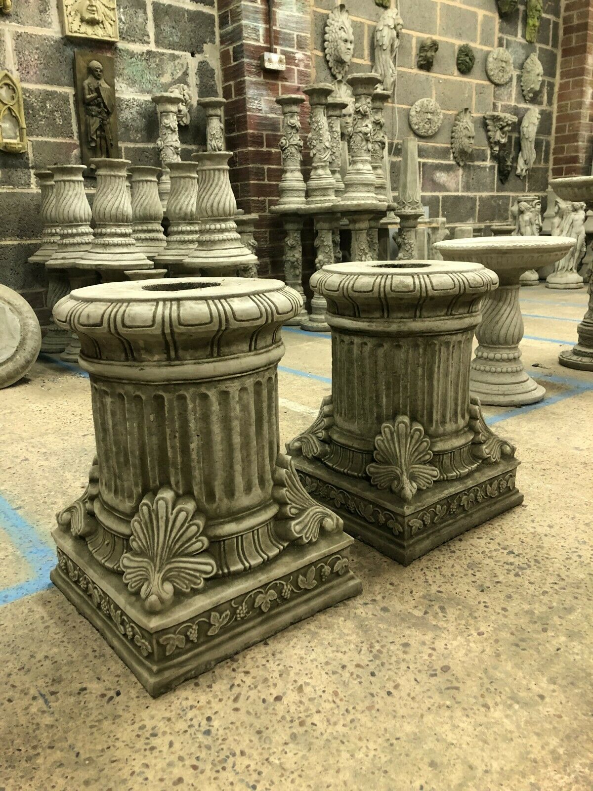 Pair of antique grey Garden Stone Pedestal Plinths with ornate detailing, ideal for outdoor sculptures or flower displays in classic garden decor.
