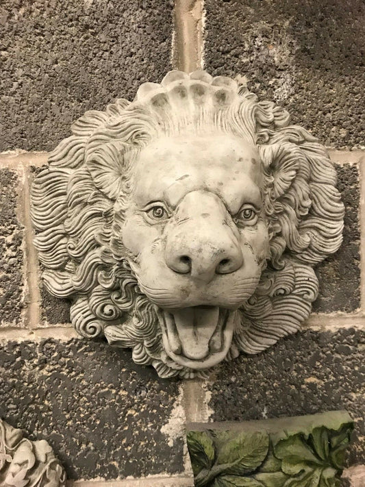 Antique Lion Water Feature with open mouth spout, crafted from durable limestone. Ideal for garden walls or pond decor in outdoor settings.