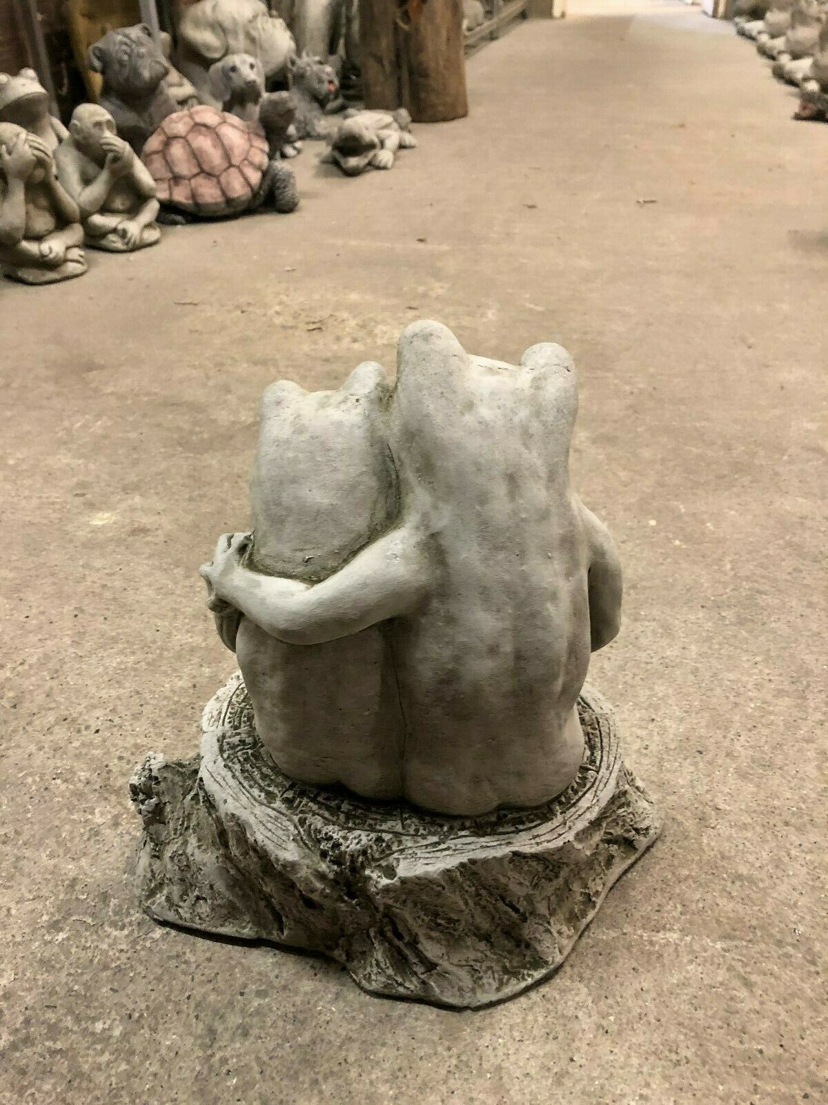 Back view of Elegant Frog Couple Ornament showing detailed stone texture and affectionate pose. Durable limestone garden sculpture for patios or lawns.