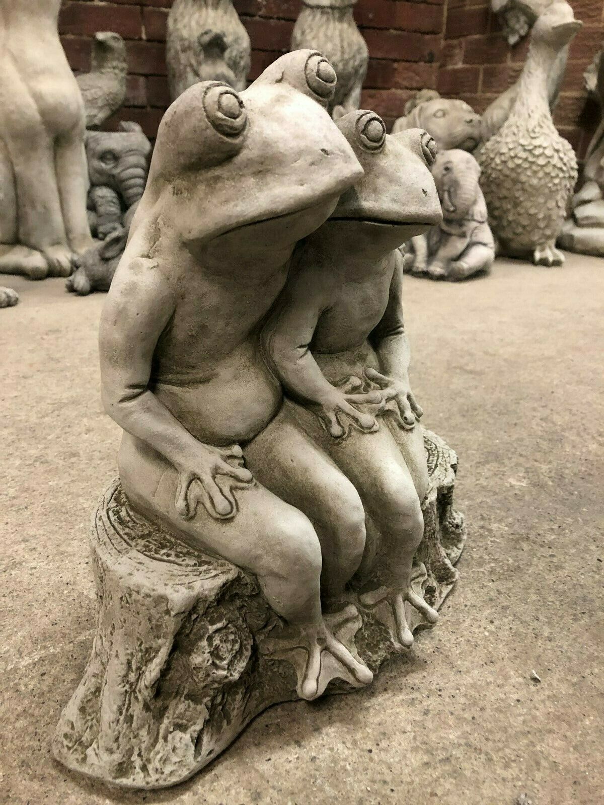 Side angle of Elegant Frog Couple Ornament with antique grey finish. Handcrafted limestone garden sculpture adds whimsical charm to outdoor spaces.