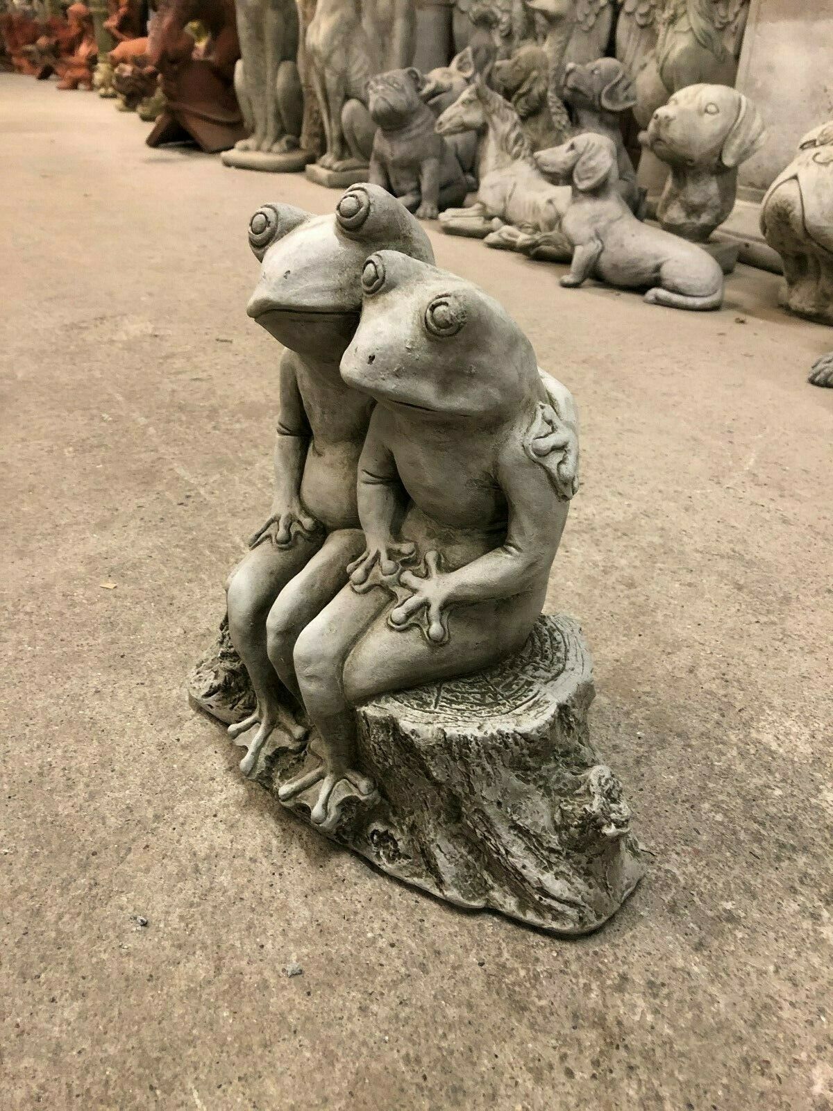 Elegant Frog Couple Ornament on tree stump base, made from weather-resistant limestone. Perfect decorative statue for garden beds or porches.