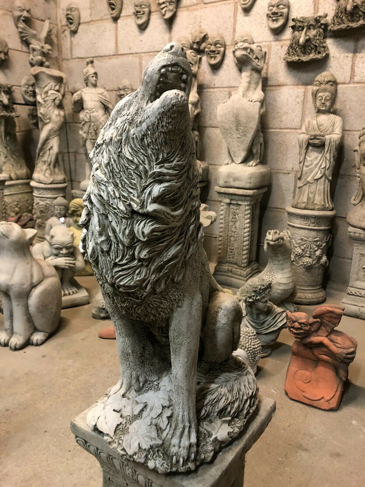 Front angle of Howling Wolf Garden Statue with realistic fur texture and antique stone finish, seated on a decorative plinth.