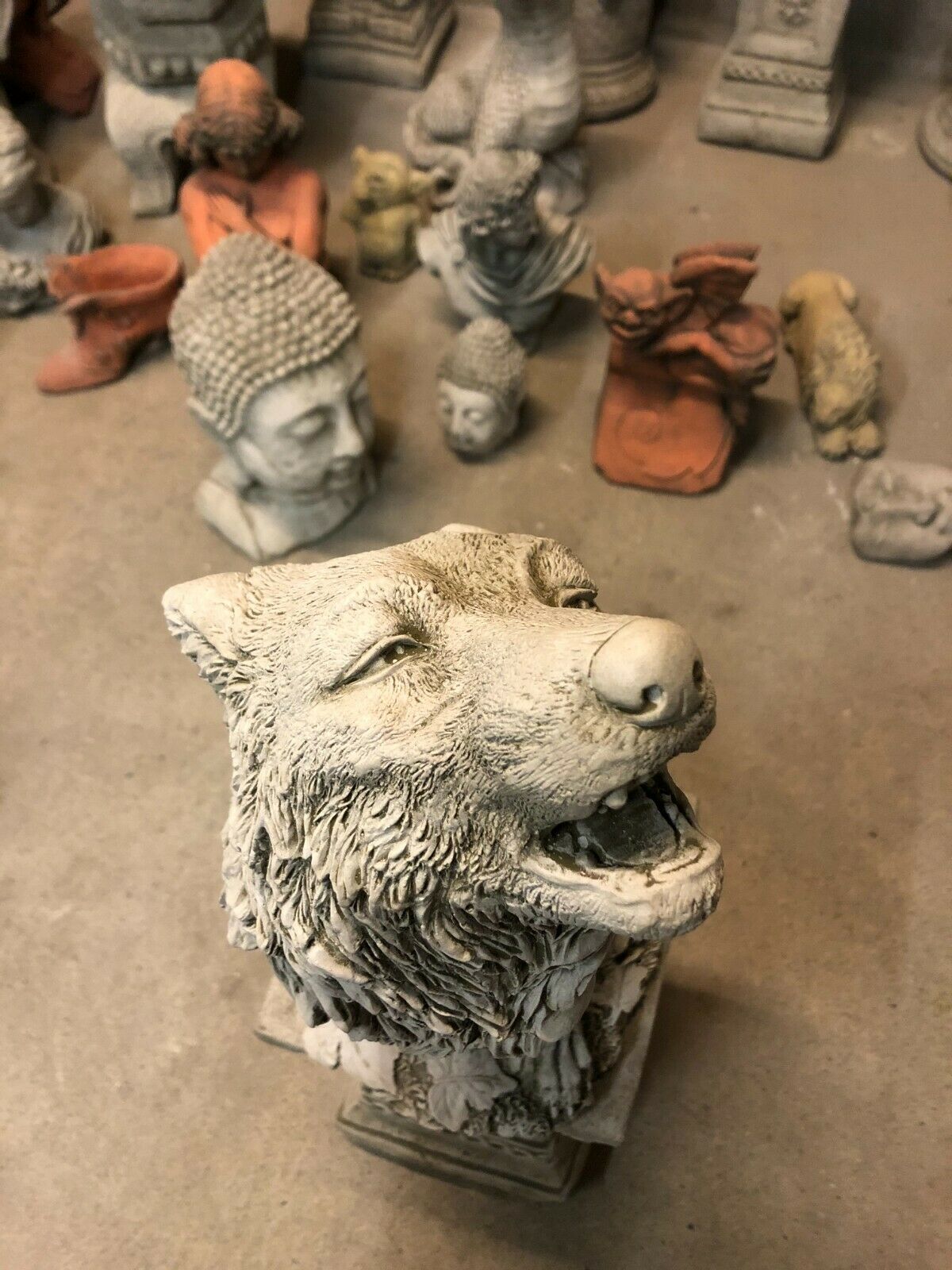 Close-up of wolf's face on the Howling Wolf Statue, highlighting expressive features and fine detailing in stone garden art.