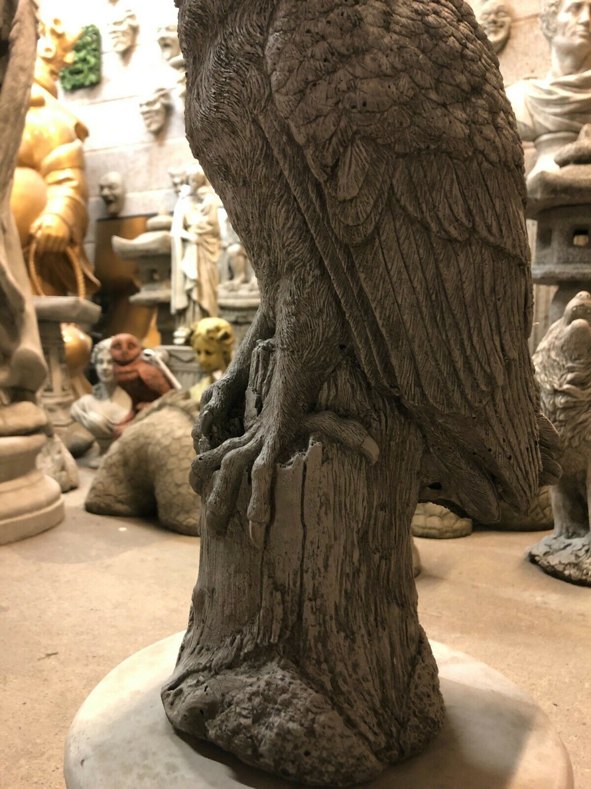 Detailed close-up of owl talons on Stone Owl Plinth Statue - Garden Decor | Solid Limestone, emphasizing realistic wood texture.