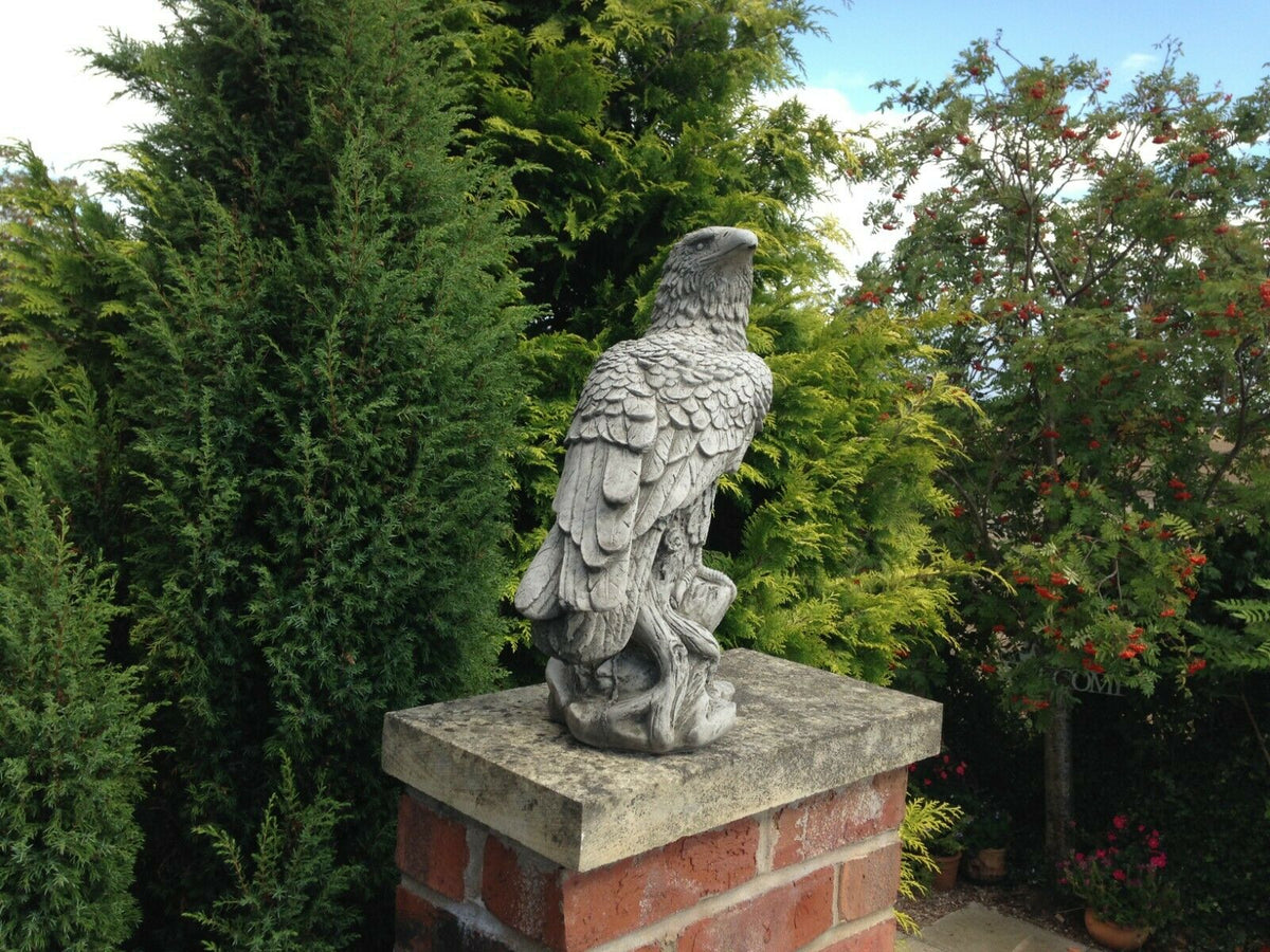 Stone Perched Eagle Statue on brick pillar, ideal for patios or lawns, crafted from durable weather-resistant limestone for garden decoration.