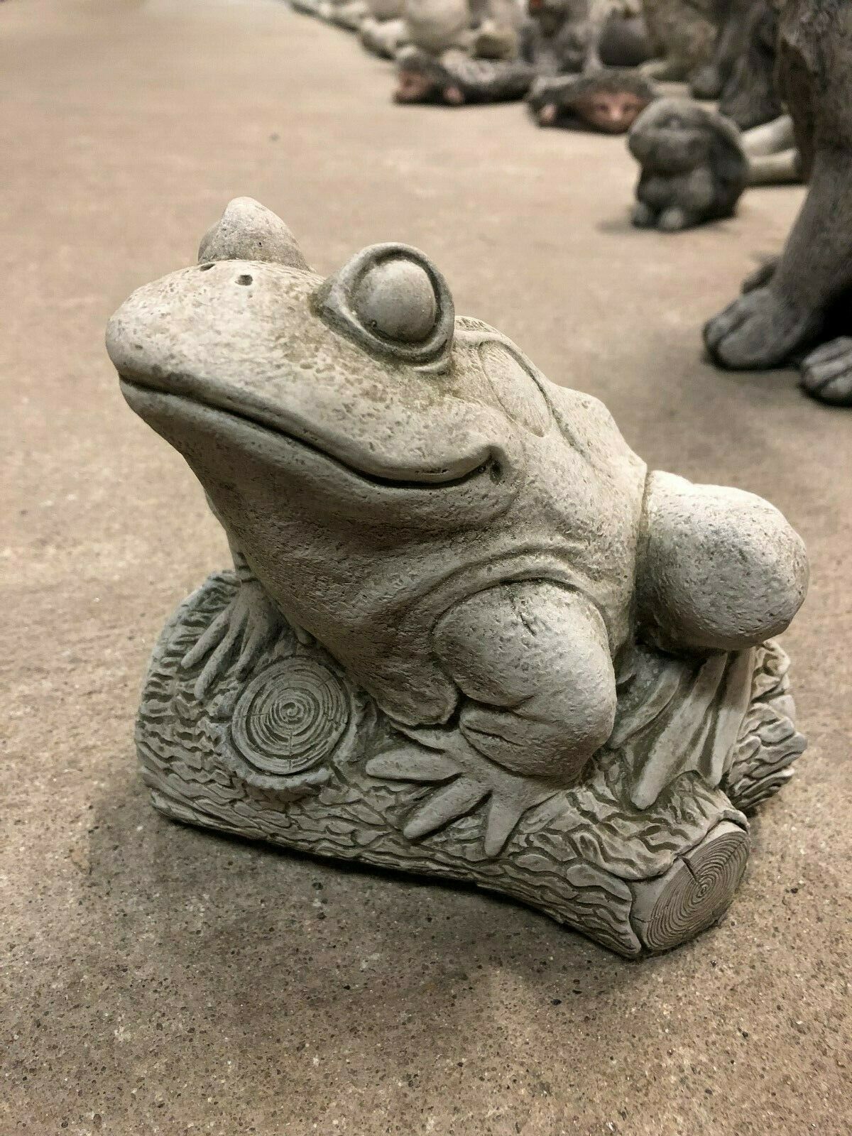 Durable limestone frog ornament perched on a carved log, perfect for enhancing patios, flowerbeds, or garden landscapes.