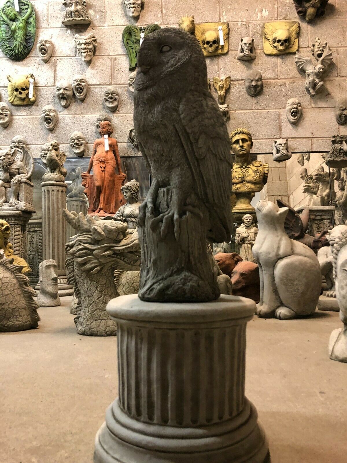 Full frontal view of Stone Owl Plinth Statue - Garden Decor | Solid Limestone placed in a decorative sculpture showroom.