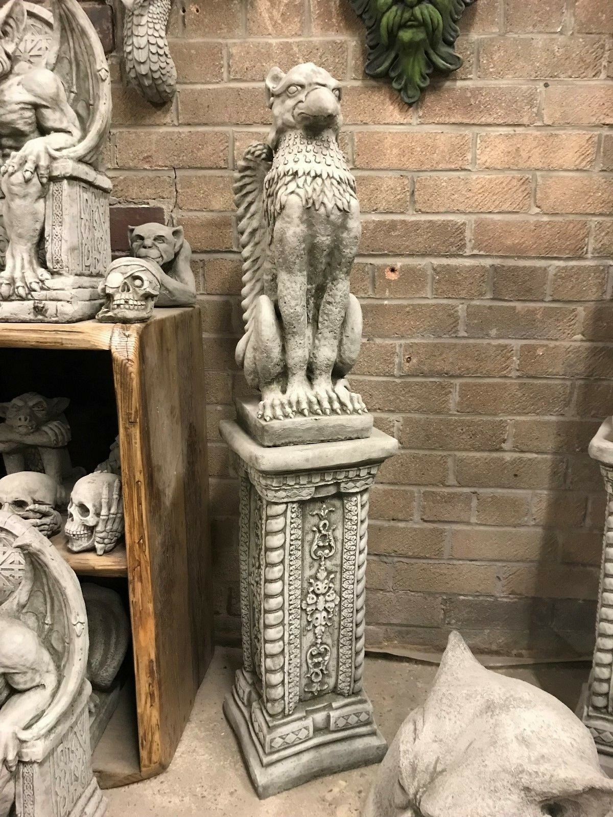Single Stone Phoenix Garden Statue on a decorated pedestal, crafted from solid stone. A striking lawn ornament for home and garden decor.