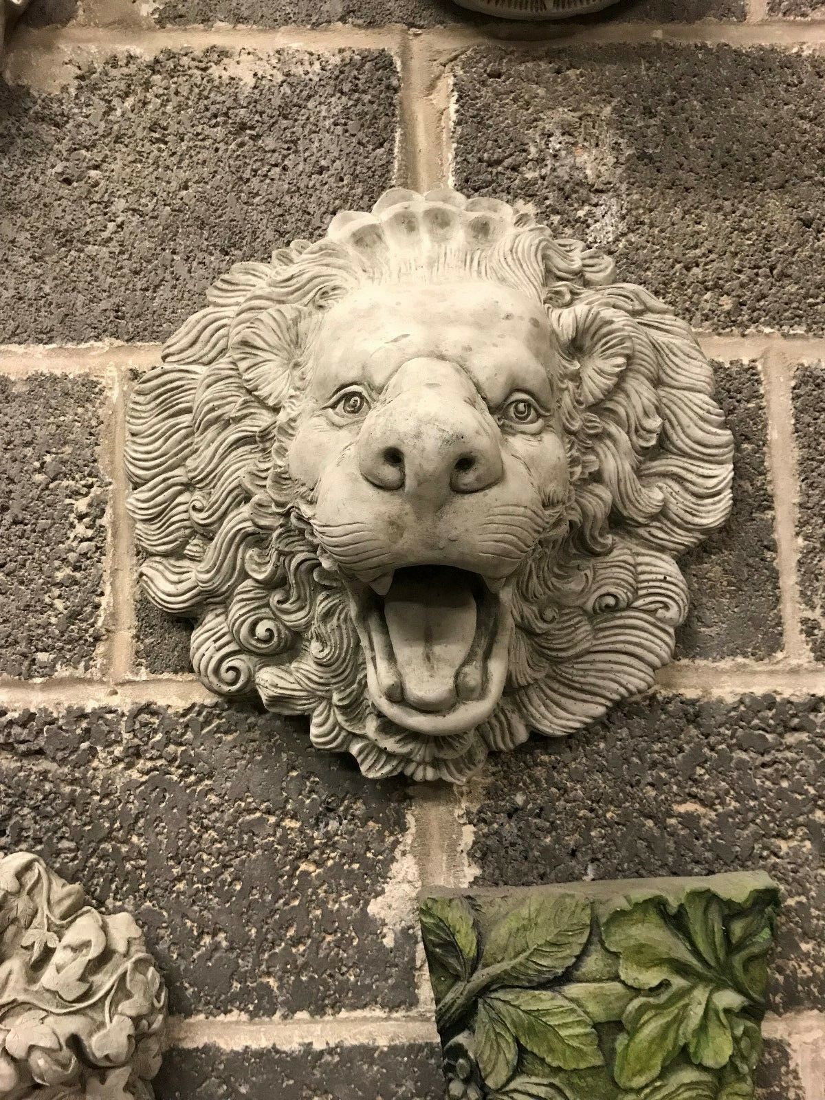 Front-facing limestone lion head water spout with intricate carving. A bold antique garden feature for fountains or ponds.