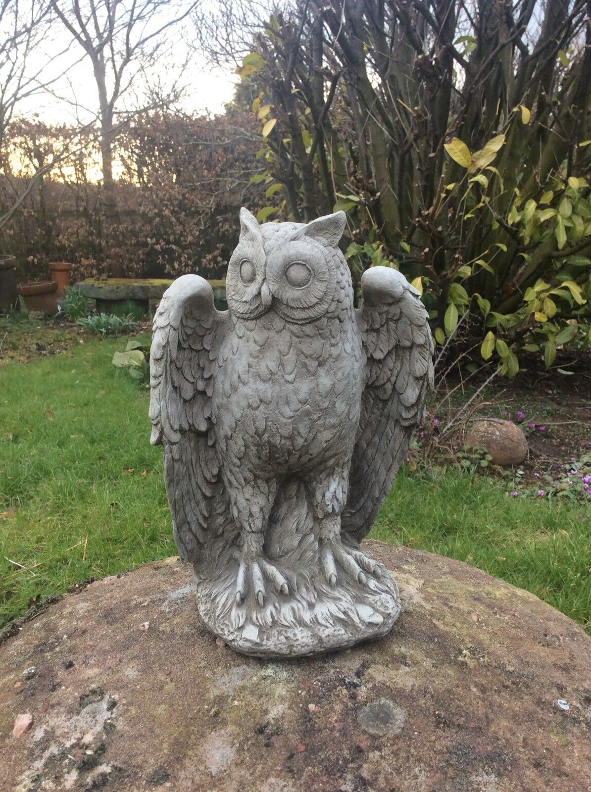 32cm Stone Owl Garden Statue - Antique Weatherproof Finish standing on a rock, perfect for enhancing flowerbeds or patios.