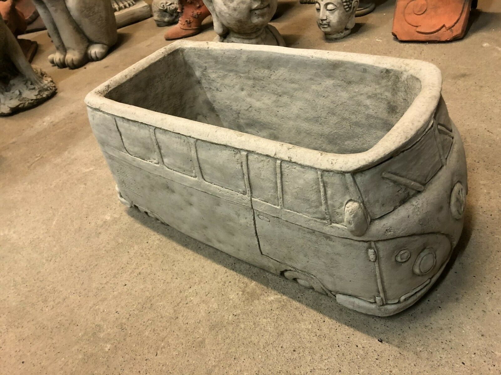 Side perspective of Stone VW Camper Van Planter highlighting its elongated planting space and realistic van detailing.