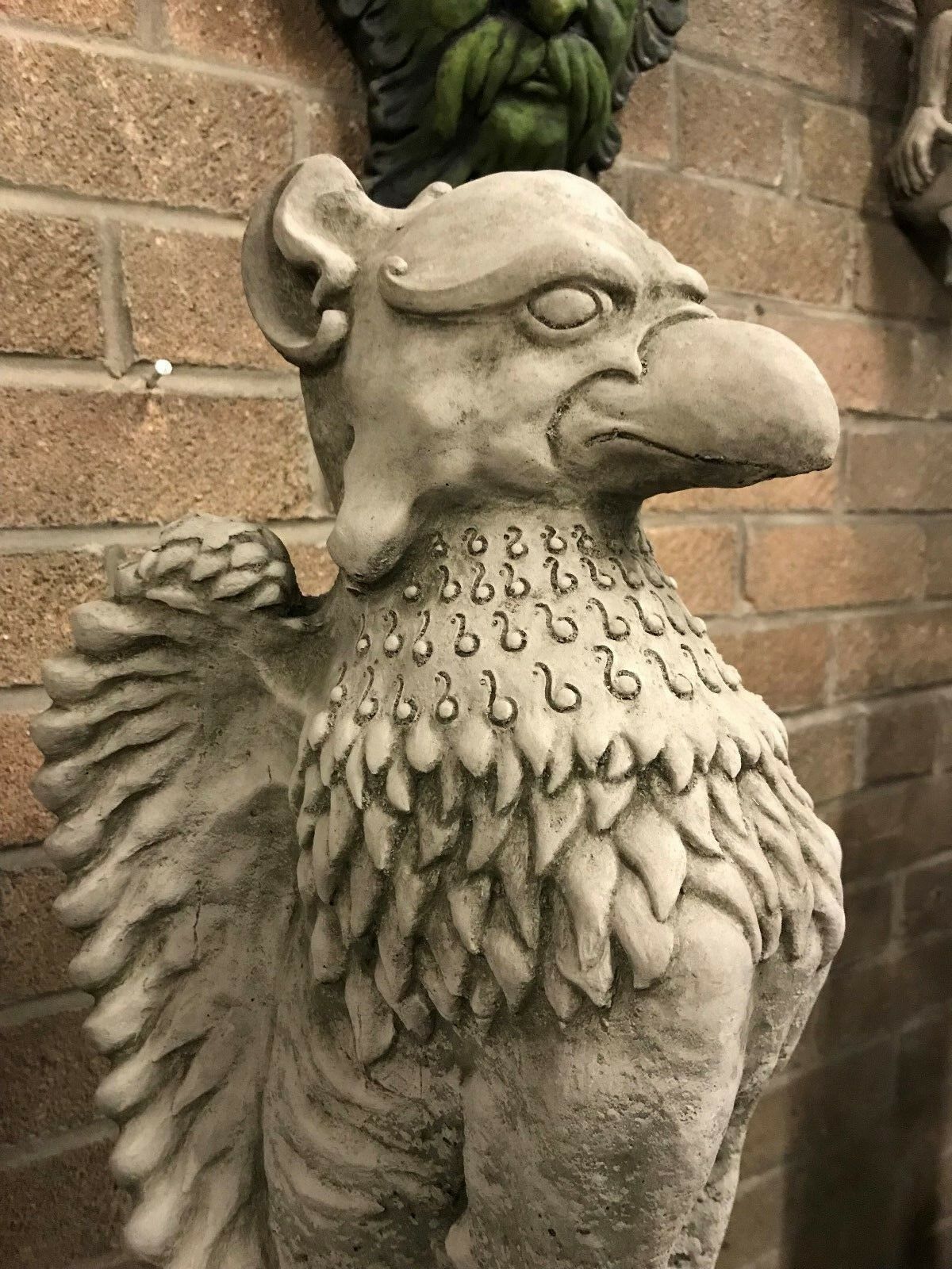 Detailed close-up of Phoenix statue's head and upper body, showcasing textured feathers and beak. A bold mythical figure for garden decor.