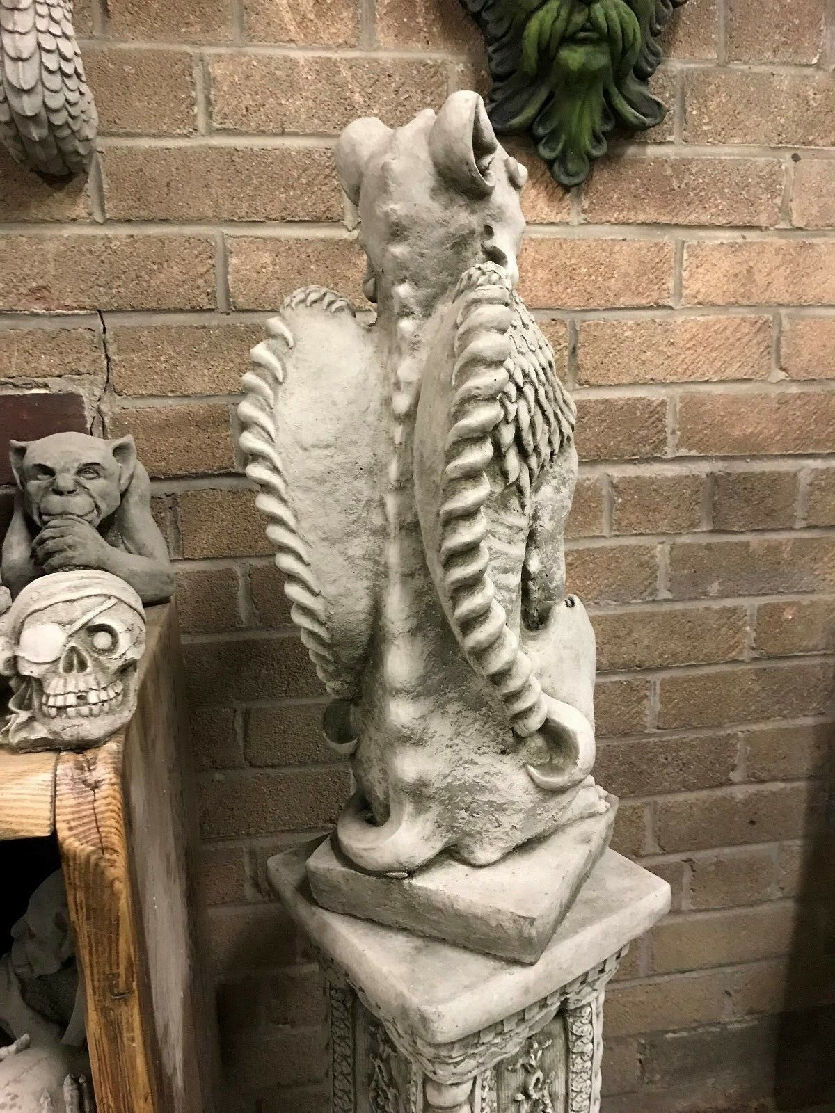 Rear view of the Phoenix Garden Statue showing sculpted wings and tail. Solid stone construction ensures durability in outdoor settings.