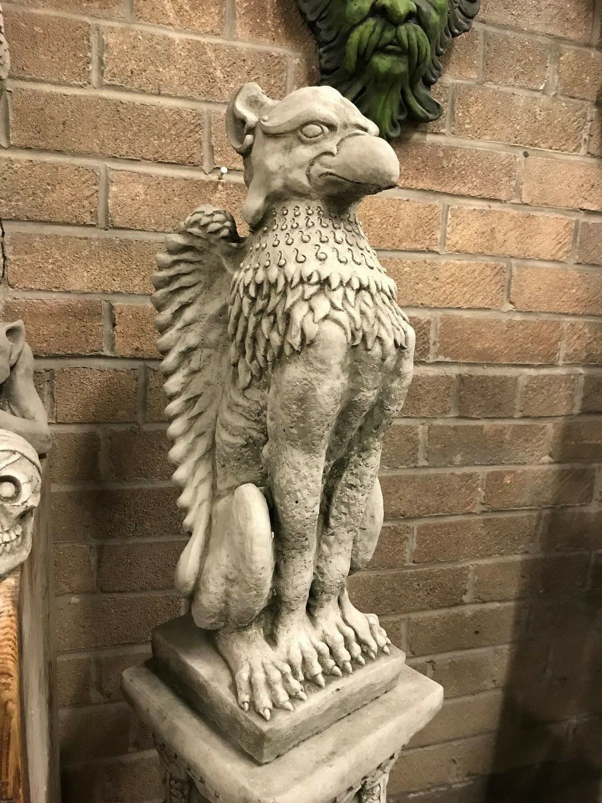 Phoenix Garden Statue on pedestal with regal posture and carved feather details. A unique mythical guardian for home and garden entrances.