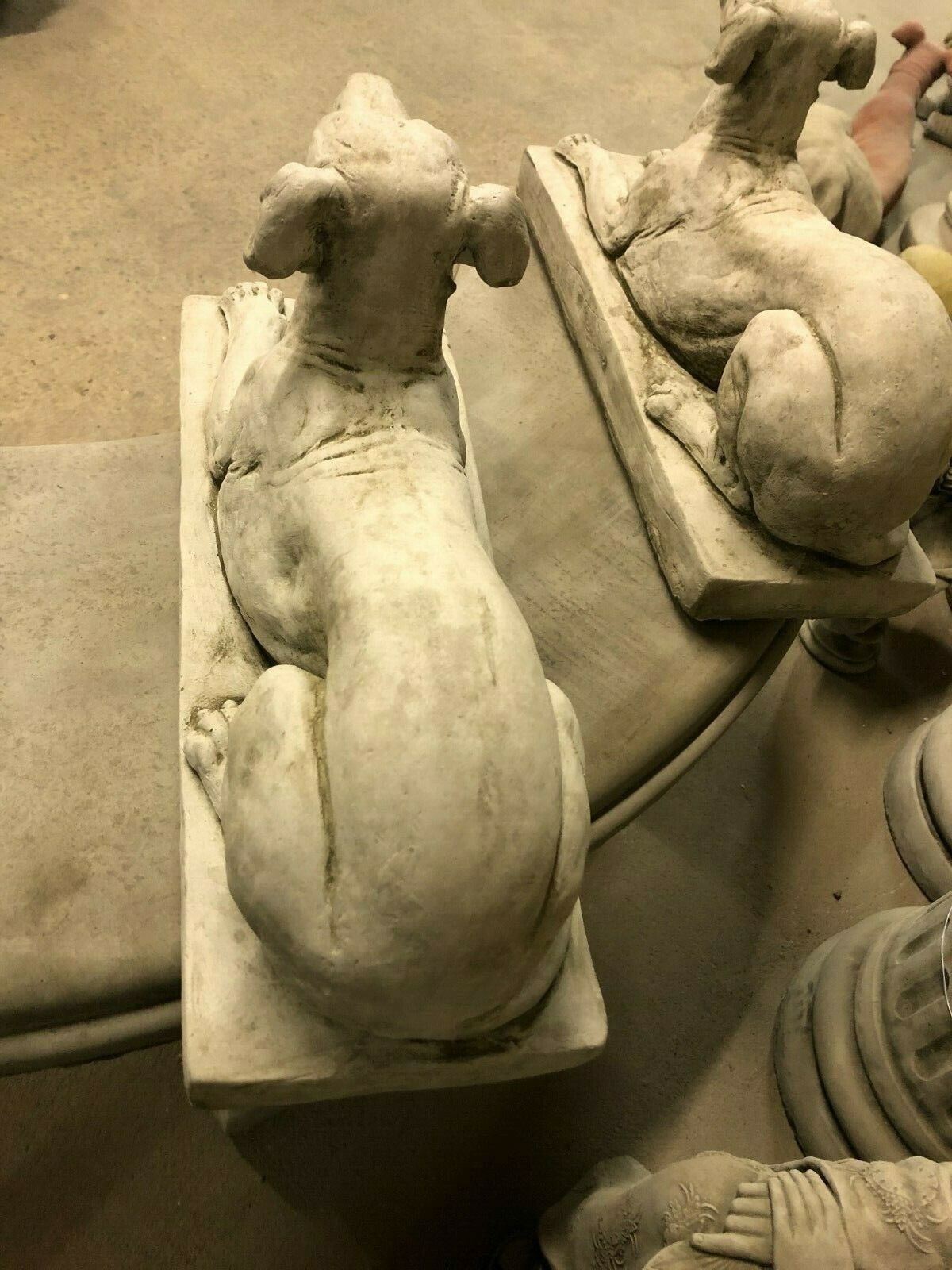 Top view of two Stone Laying Greyhound Dog Statues, highlighting realistic contours and weather-resistant stone texture.