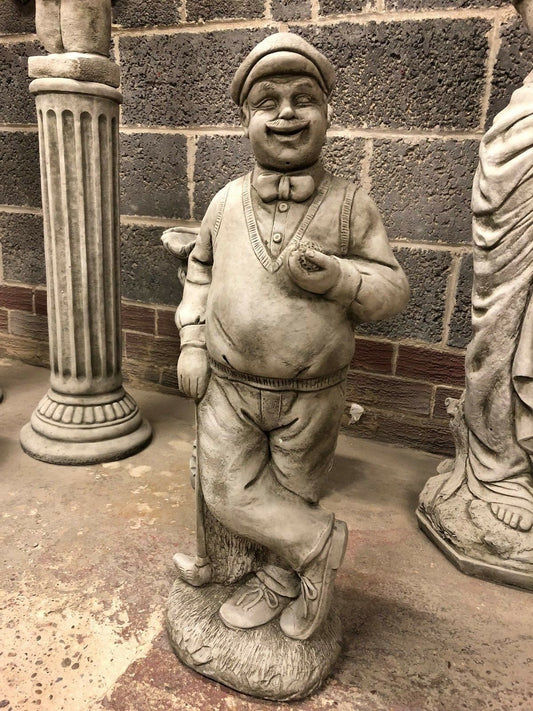 Stone Golfer Garden Statue in antique finish, featuring a smiling man in vintage golf attire holding a ball and club. Ideal for outdoor garden decor.