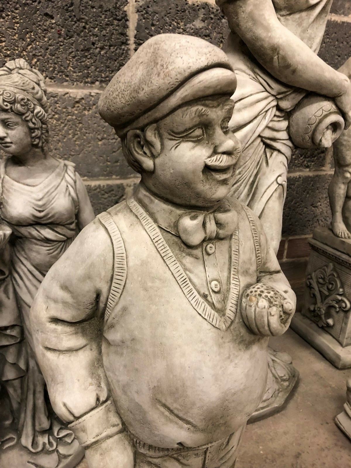 Close-up of Stone Golfer Garden Statue’s facial expression and vintage outfit, highlighting the antique finish and limestone texture for outdoor use.