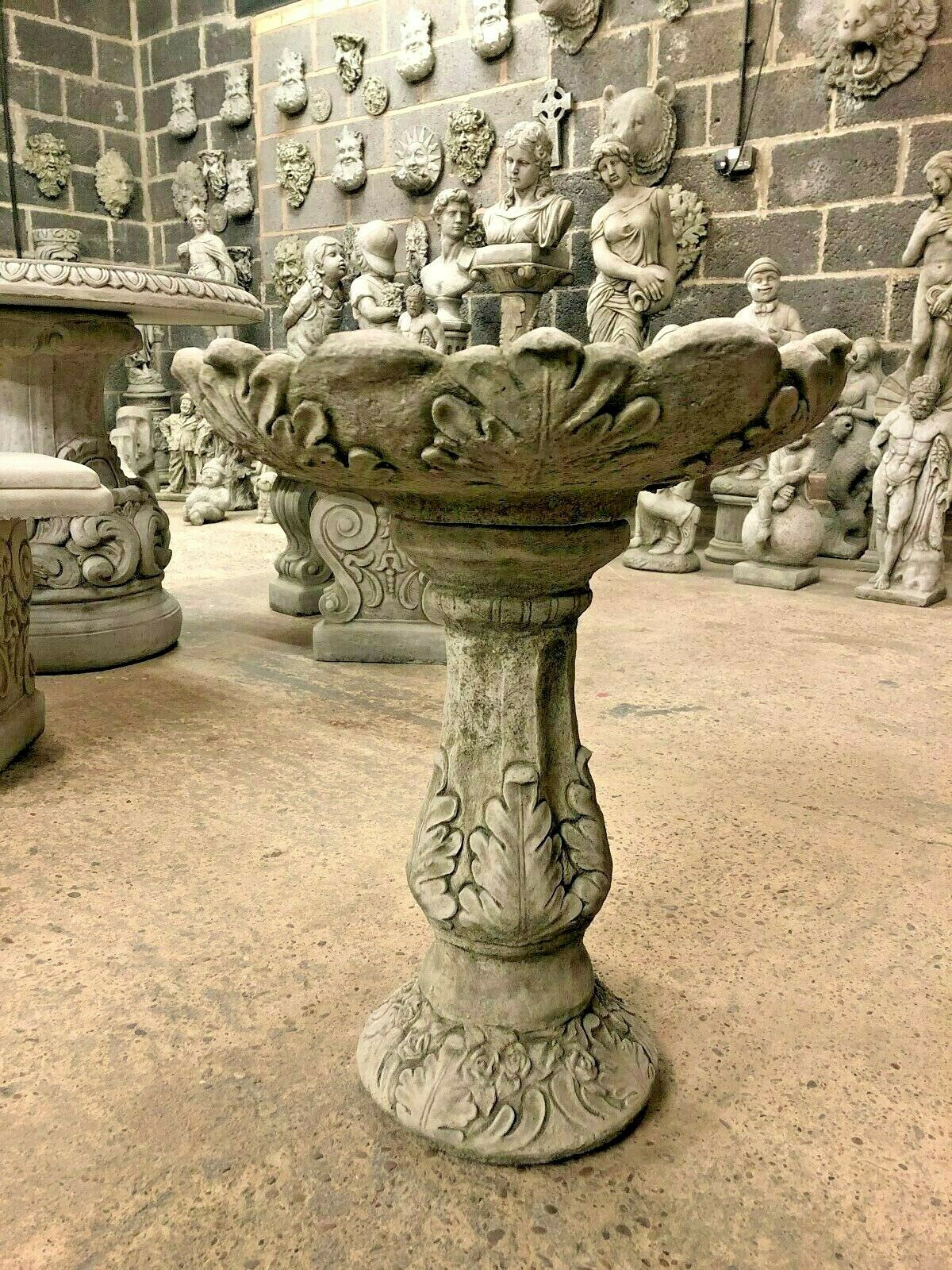 Garden Bird Bath - Leaf Design Stone with ornate leaf carvings on pedestal and bowl, ideal decorative feature for outdoor spaces.