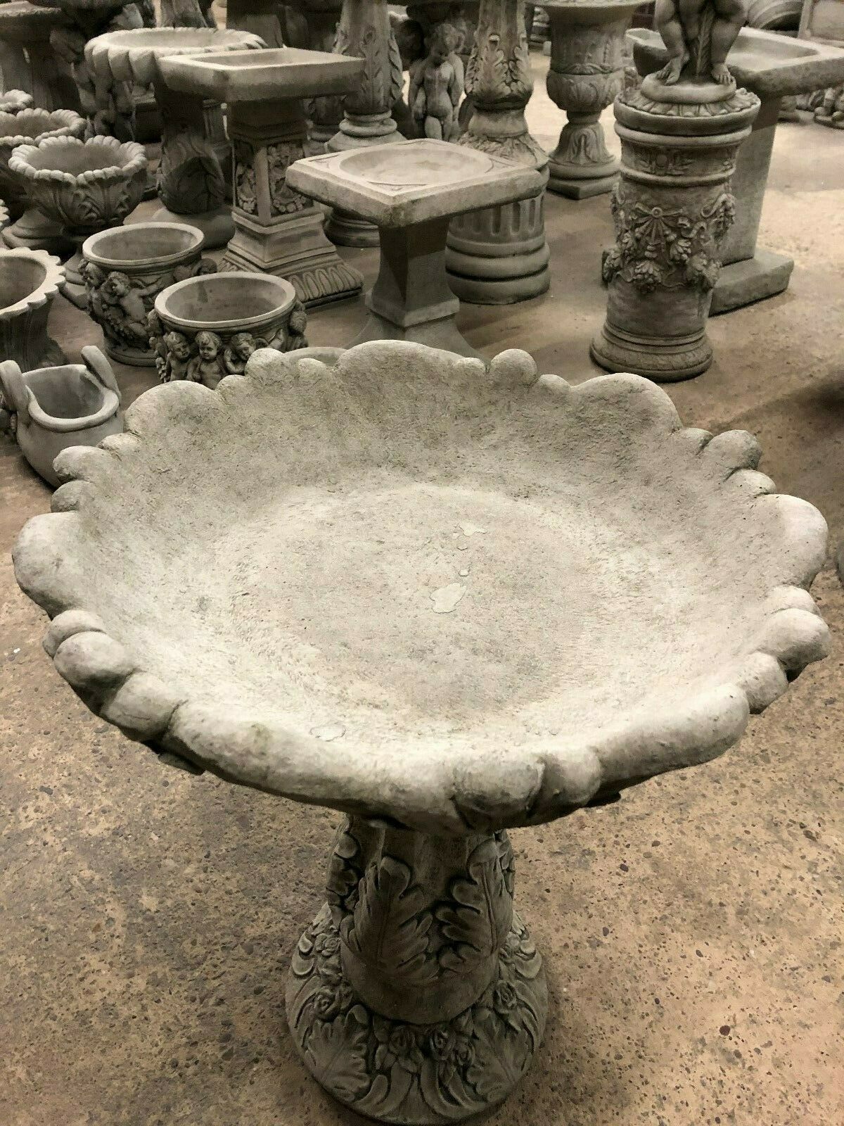 Elegant Garden Bird Bath in stone with wide leaf-patterned basin, perfect for attracting birds to patios or landscaped gardens.