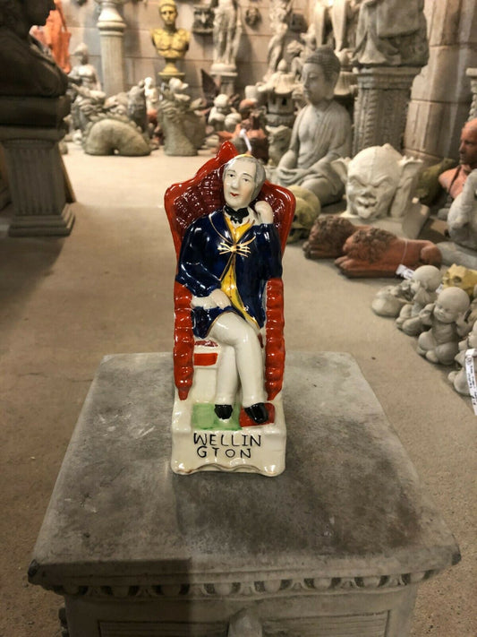 Ceramic Duke Wellington Ornament - Handcrafted Art | Free UK Delivery. Seated figurine of Duke Wellington in blue coat on red chair, 17cm tall.