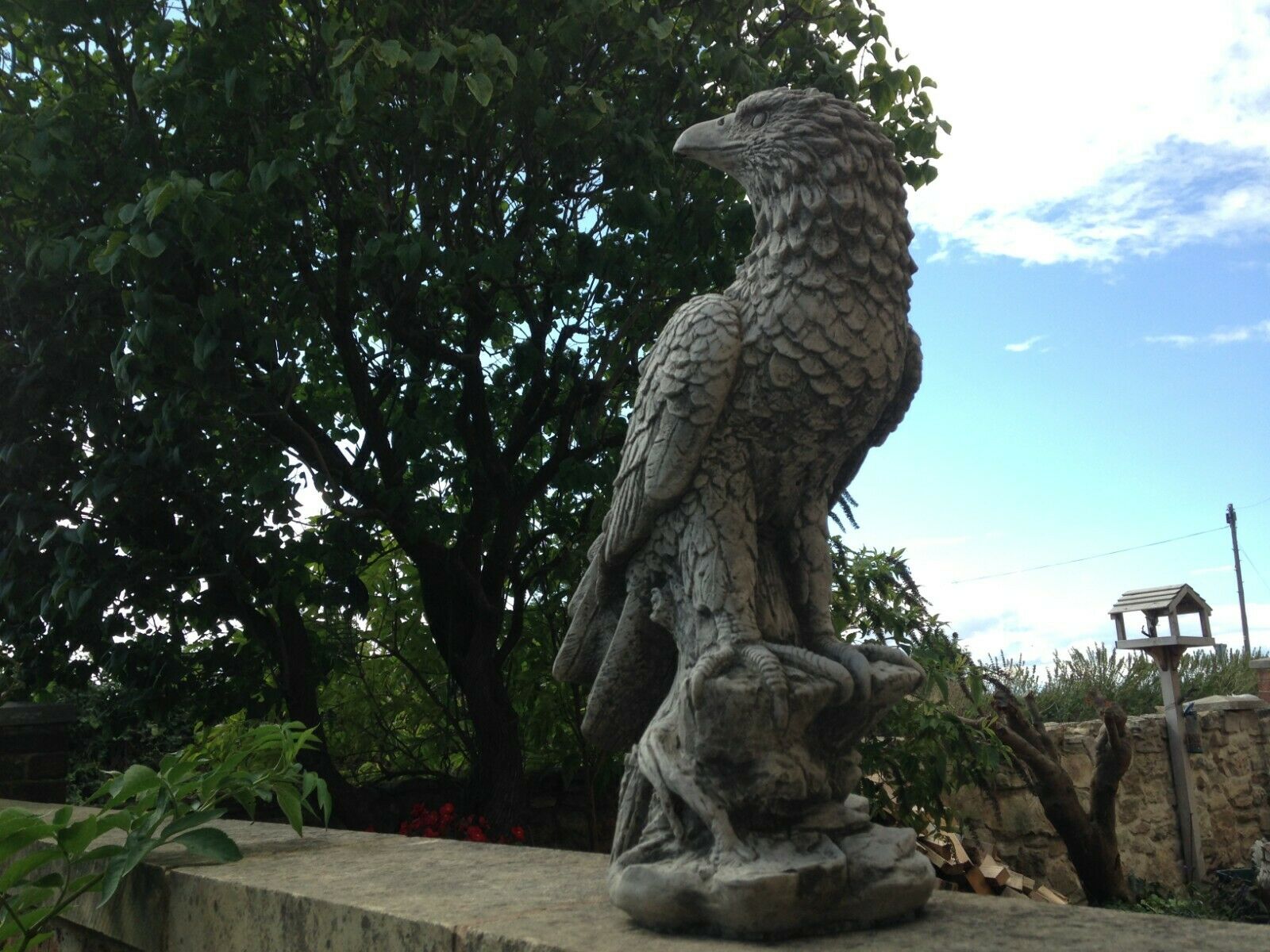 Detailed Stone Perched Eagle Statue in garden setting, made from solid limestone with a weatherproof finish for lasting outdoor decor.