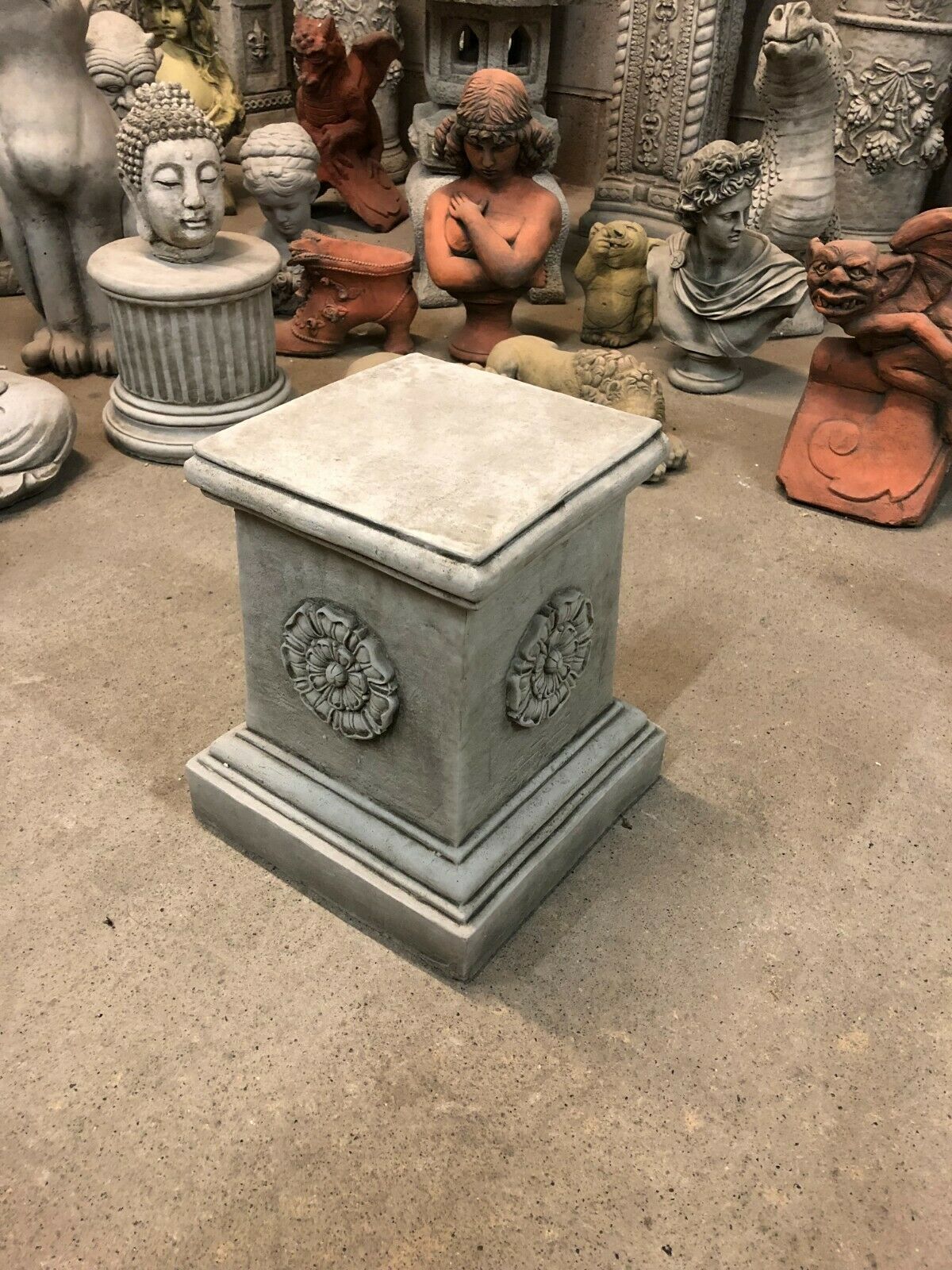Heavy stone garden plinth featuring Yorkshire Rose motif, perfect for outdoor decor or supporting statues in home and garden settings.