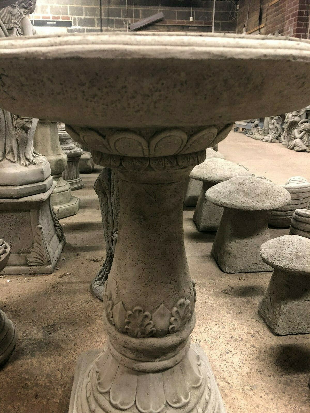 Side profile of Garden Bird Bath - Stone Traditional Style showing fluted pedestal and carved leaf motifs. A timeless addition to garden decor.