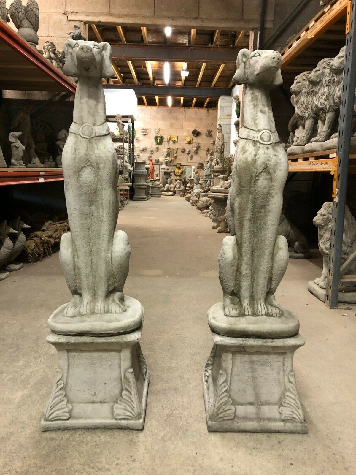 Elegant Dog Statues - Greyhound Garden Decor with tall stone greyhound sculptures on plinths, ideal for outdoor lawn or patio display.